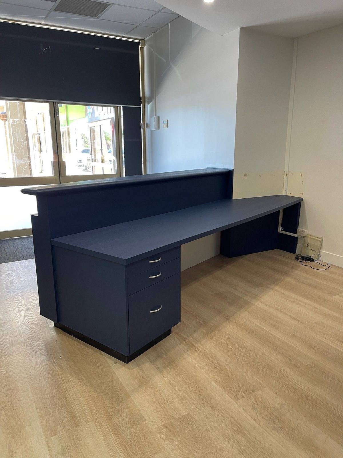 Navy blue reception desk wrap · Cambridge